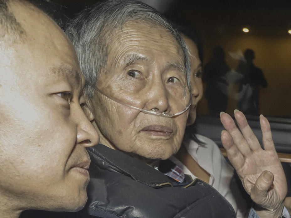 Former Peruvian President Alberto Fujimori sits between his children Kenji (left) and Keiko upon his release from the Barbadillo prison in the eastern outskirts of Lima, on Wednesday.