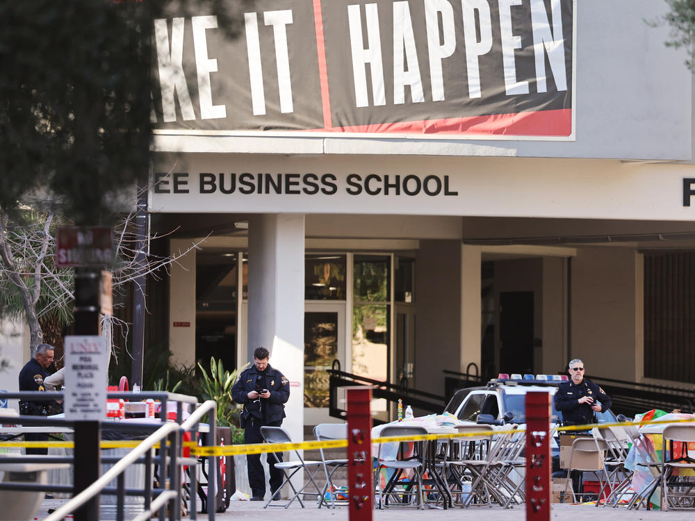 Police officers keep watch Thursday near the scene outside Frank and Estella Beam Hall, where the UNLV Lee Business School is located, the morning after a shooting left three dead at the University of Nevada, Las Vegas campus.