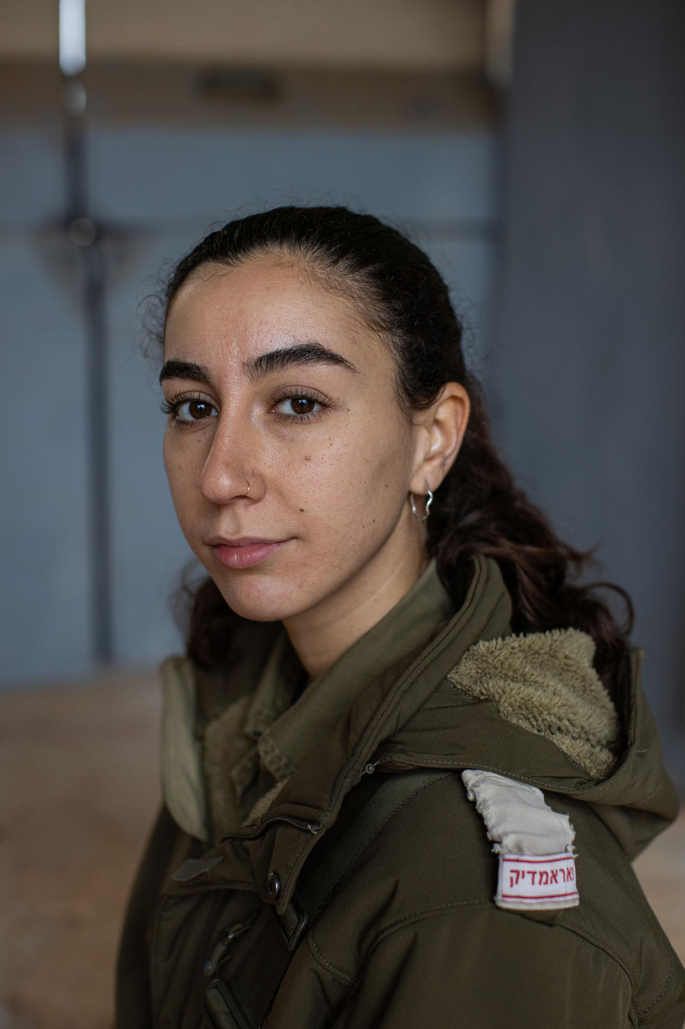 Zohar Ben Shushan, an Israeli military reservist and paramedic, sits for a portrait at a military base near the border with Lebanon in northern Israel on Nov. 28.