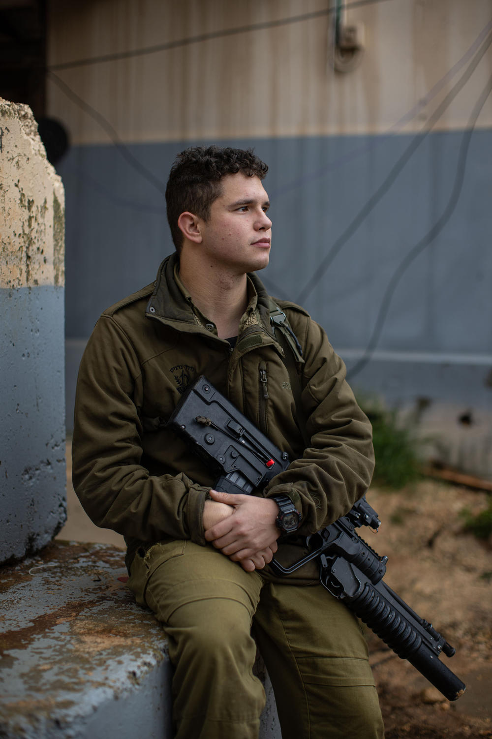 Max Sherman, an Israeli military reservist, sits for a portrait at a military base near the border with Lebanon in northern Israel.