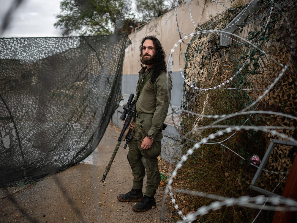 Amit Michelson, an Israeli military reservist, stands for a portrait at a military base near the border with Lebanon in northern Israel on Nov. 28.