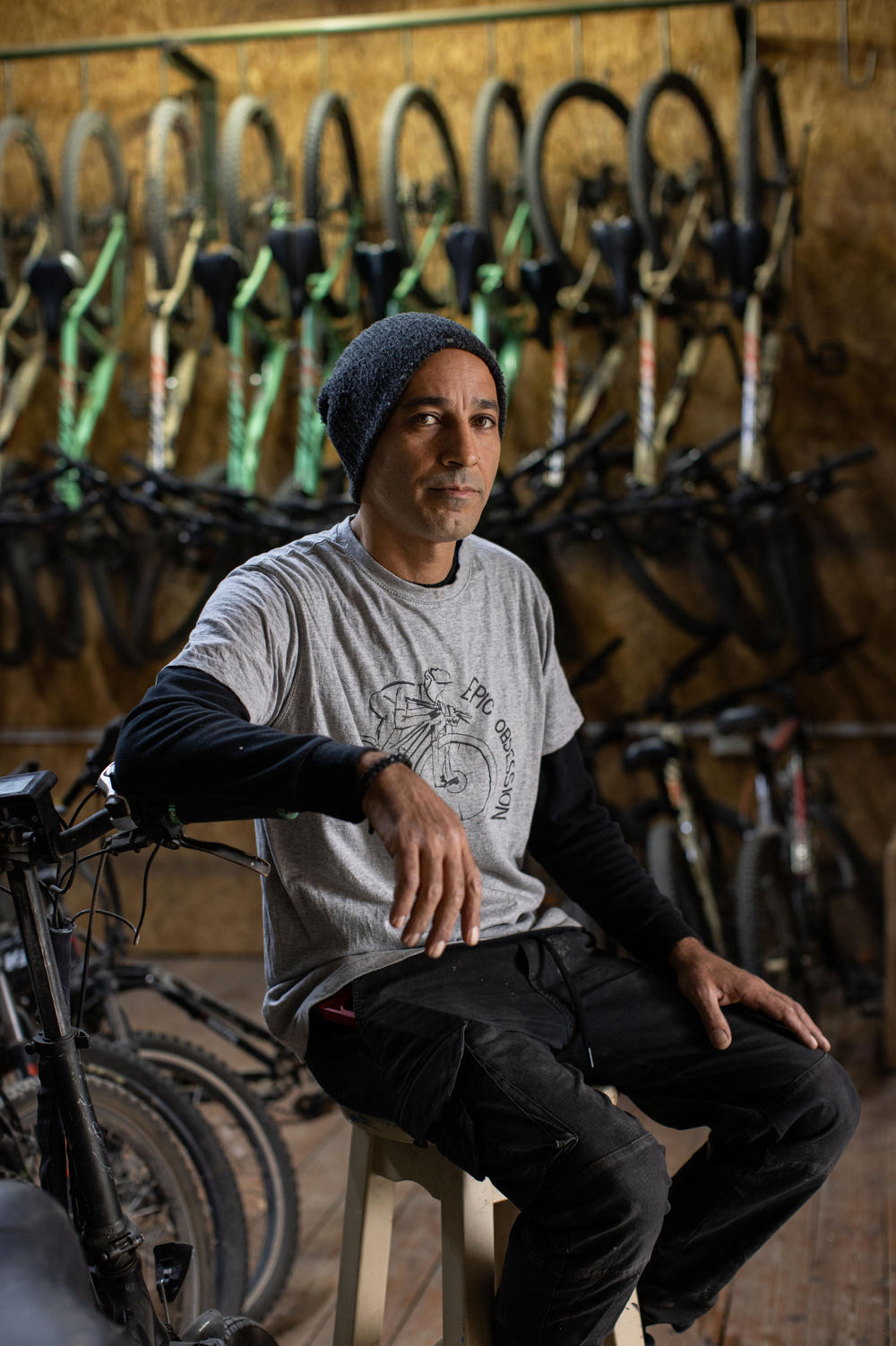 Raanan Momika, who runs a cycling tourism business, sits for a portrait in his shop at Lehavot Habashan, a kibbutz in northern Israel near the border with Lebanon, on Nov. 28.