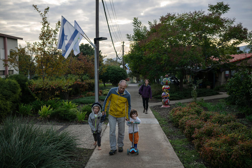 Yoav Rotem, his wife Michal Inerman and their children Sahar Inerman, 2, and Harel Inerman, 7, walk through Kfar Szold, a kibbutz in northern Israel near the border with Lebanon, on Nov. 28.