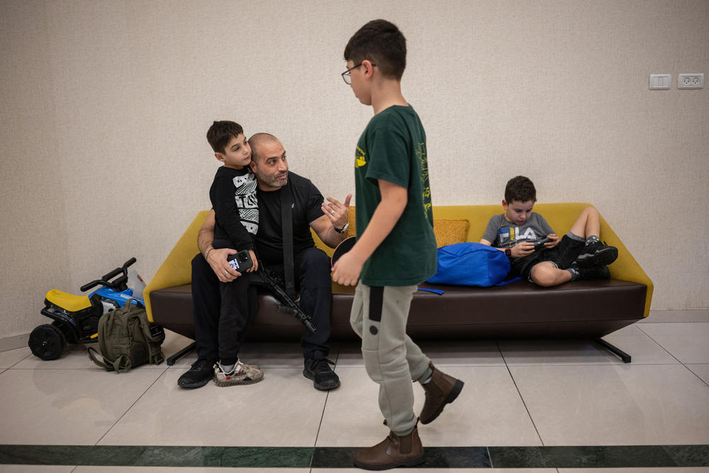 Michel Fajima talks with his son Oria Fajima, 6, at the Ramada Hotel in Nazareth, Israel, where they have been living since being evacuated from Snir, their kibbutz in northern Israel located a few kilometers from the border with Lebanon, on Nov. 28.
