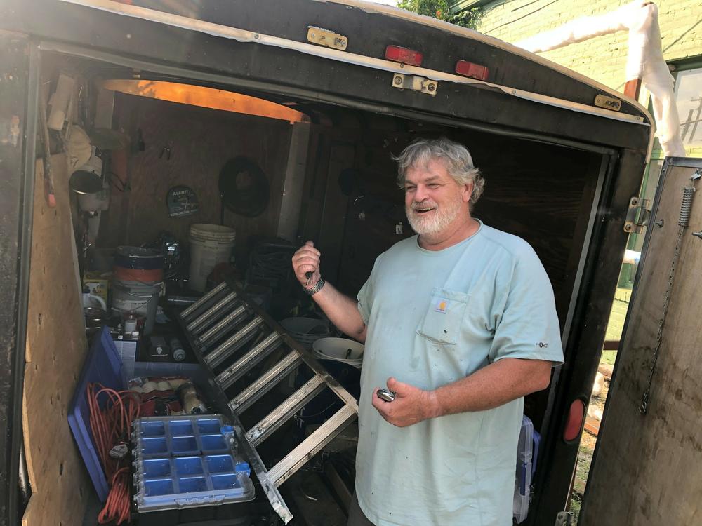 Doug Layton, Jr. shows a trailer full of equipment he's acquired since being released from prison. He says he does painting and home repairs on the side, 