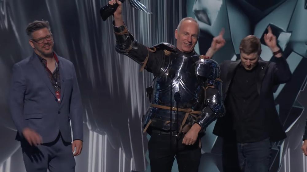 Larian Studios CEO Swen Vincke, center, celebrates the big win for Baldur's Gate 3 in plate armor.