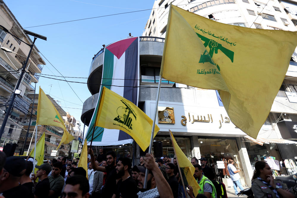 Hezbollah supporters carry flags as they gather to commemorate the annual Hezbollah Martyrs' Day and to express solidarity with the Palestinians in Gaza amid the ongoing conflict between Israel and Hamas, in Sidon, Lebanon, Nov. 10, 2023.