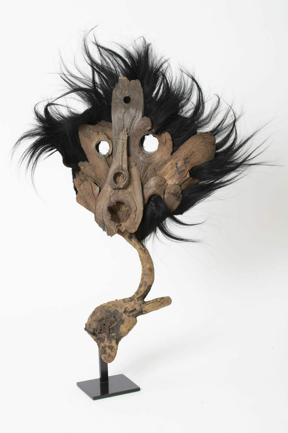 <em>Black Scarecrow mask,</em> Leonor Fini, c.1960, Round holes for eyes, black thick felt fabric, mounted on stand of driftwood tree branch (found in Corsica)