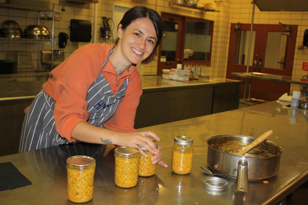 Maritza Arellano, a dietetic intern at Montana State University, works with the Buffalo Nations Food Systems Initiative to can hot sauce made from produce from an Indigenous garden in Bozeman, Mont.