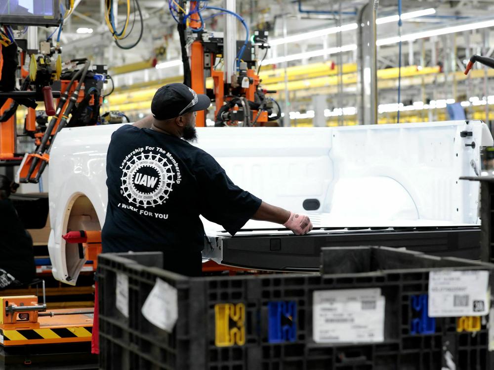 A person works at Ford's Rouge Electric Vehicle Center in Dearborn, Mich. on Sept. 20, 2022. U.S. employers created 199,000 jobns last month, higher than in October, in part as UAW workers returned to work after a strike against the Big Three automakers.