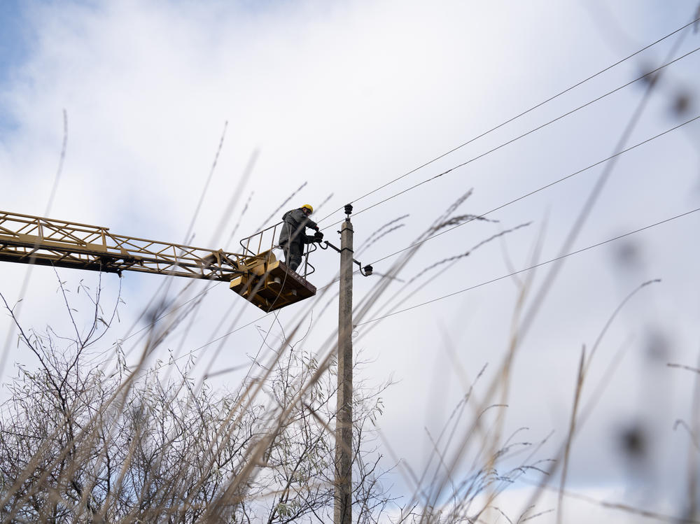 Utility workers north of Lyman, Ukraine, work on restringing electrical poles in an effort to brace the country's energy system against another winter of expected Russian attacks.