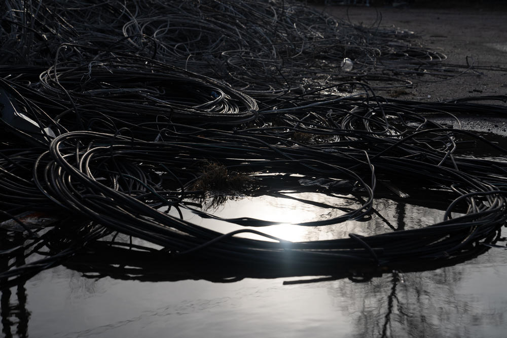 Piles of used and damaged wires are set aside to be recycled in a lot in Lyman.