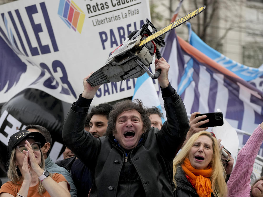 Presidential hopeful Javier Milei brandishes a chainsaw during a campaign rally in La Plata, Argentina, Sept. 12, 2023.