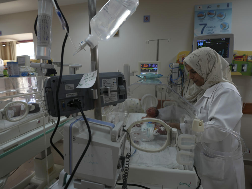 A Palestinian doctor treats a prematurely born baby at Al Aqsa Hospital in Gaza on Sunday, Dec. 10, 2023.