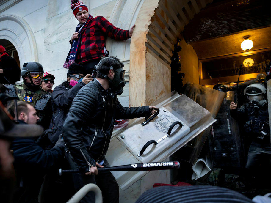 Federal prosecutors allege that the man in the black jacket is Jacob Lang and that he used a bat and stolen police shield to assault police guarding the Capitol. Lang pleaded not guilty and is still awaiting trial. He has praised Trump for promising to pardon Jan. 6 defendants and said he hopes Trump issues a blanket pardon for everyone facing charges.