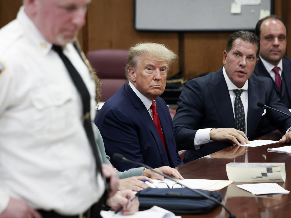 Former President Donald Trump sits in the courtroom with his attorneys Joe Tacopina and Boris Epshteyn (right) during his arraignment at the Manhattan Criminal Court on April 4 in New York City.