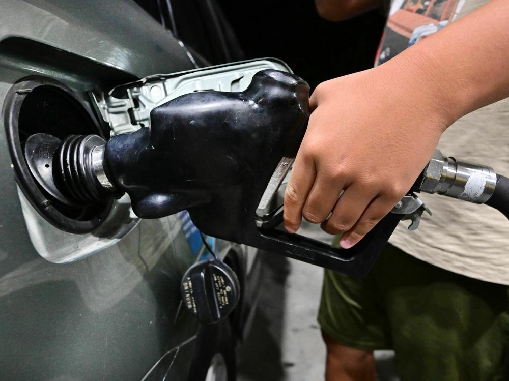 A man pumps gas in Alhambra, Calif., on Oct. 2, 2023.