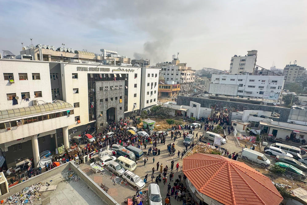 Displaced Palestinians gather in the yard of Gaza's Al-Shifa hospital on December 10 as battles continue between Israel and the militant group Hamas.