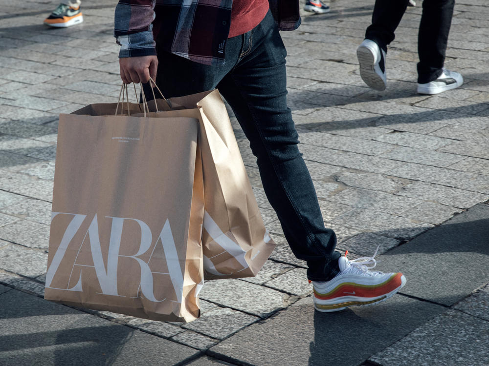 A shopper carries Zara shopping bags in Paris. The fashion company said it regrets that some customers were offended by its latest ad campaign.