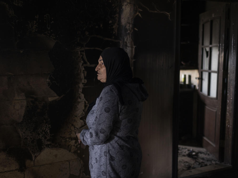 Widad Ghareeb visits a neighbor's house that was destroyed by an Israeli attack during fighting between Israel and Lebanese Hezbollah forces that escalated when the latest Gaza war began. Ghareeb's home next door was also heavily damaged.