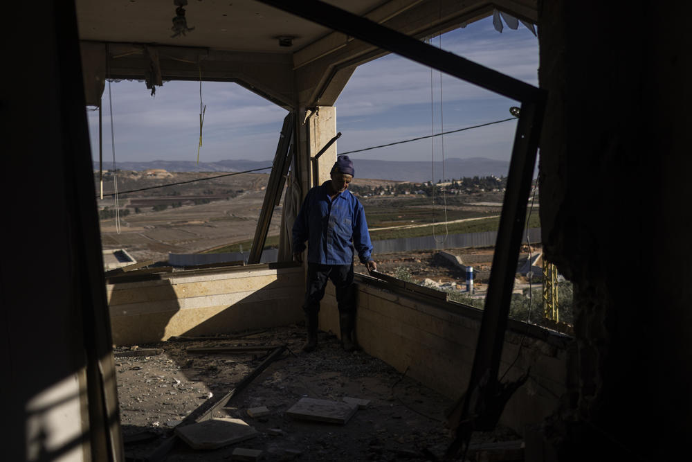 Ibrahim Hamoud checks out his destroyed home. He worked as a house framer for five years in Africa to save money to build his dream house in Lebanon.