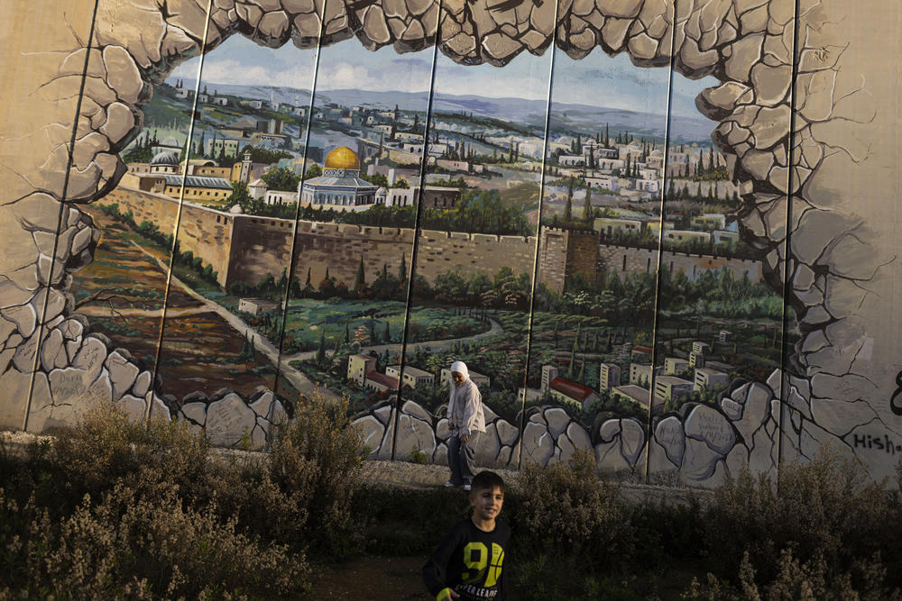 Two children play near the Israeli border wall in the village of Kfar Kela, in southern Lebanon.