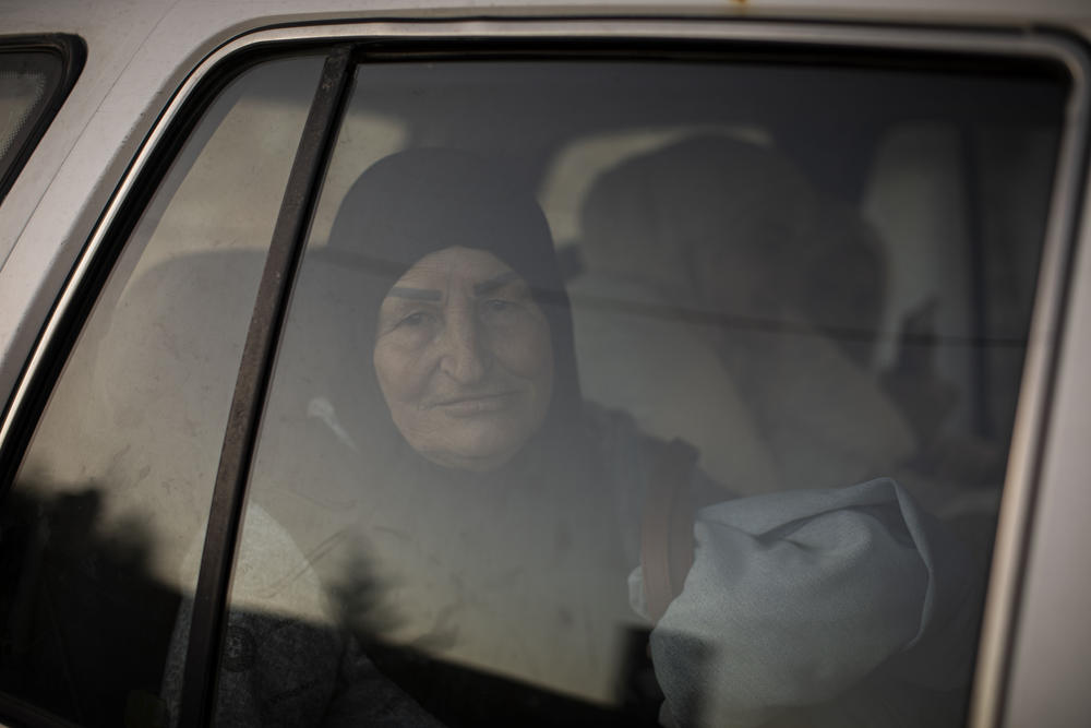 Widad Ghareeb on her way to a relative's house. Her house was heavily damaged. She has four children and 13 grandchildren and leaves the area at night to stay with one of her daughters.