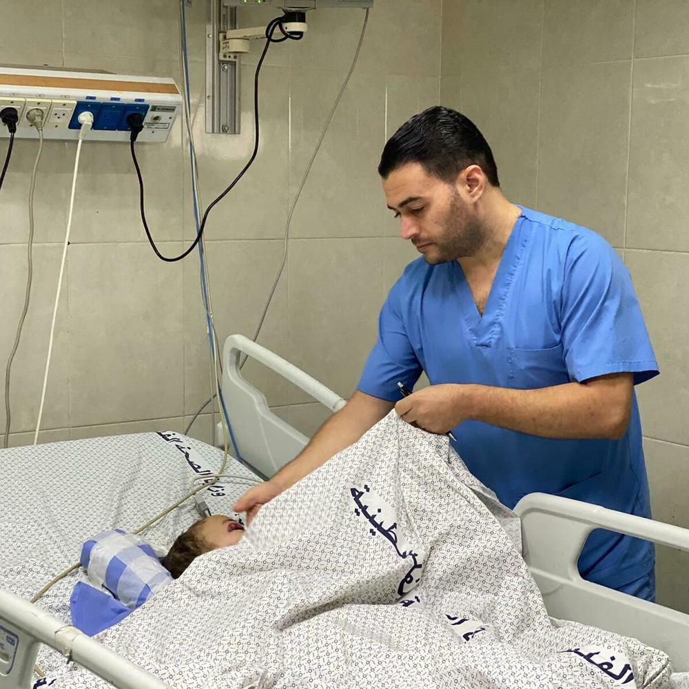 ICU nurse Dr. Samer Mansour tends a patient at Nasser Medical Complex in Khan Younis, on Monday.