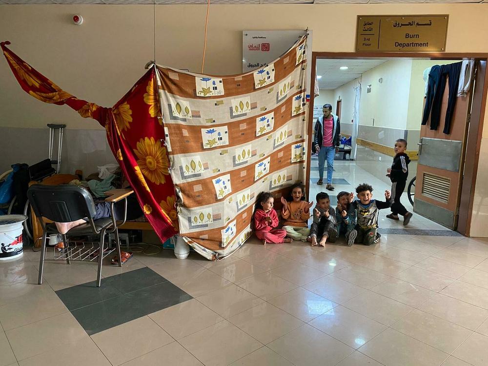 Children in Nasser Medical Complex in Khan Younis play in the corridor next to the hospital's burn unit, on Monday.