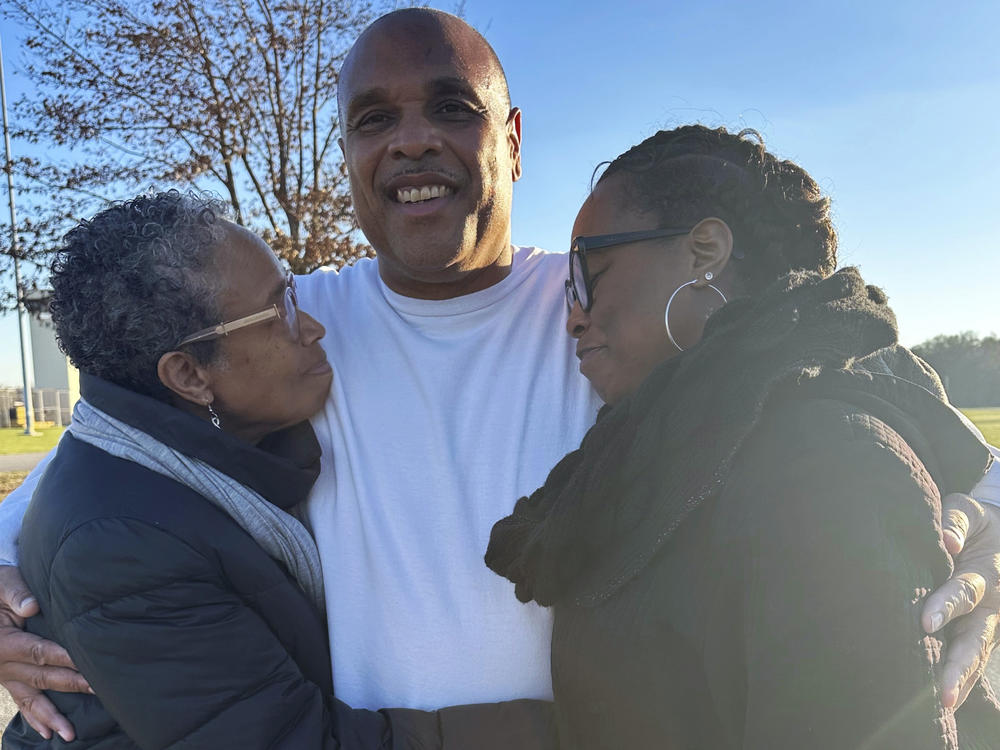 In this photo provided by Laura Nirider, Brian Beals, center, who was exonerated on a murder charge and released from a downstate prison after 35 years behind bars, hugs his sister Pattilyn Beals, left, and niece Tamiko Beals outside Robinson Correctional Institution, in Robinson, Ill., on Tuesday, Dec. 12, 2023.