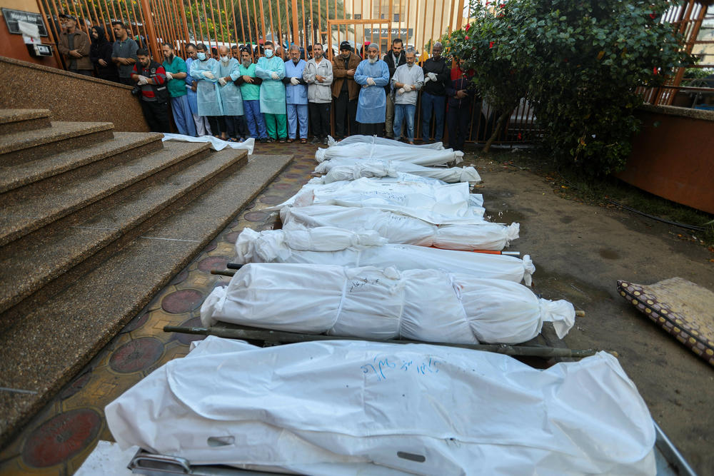 People mourn as they collect the bodies of Palestinians killed in an airstrike on December 13, 2023 in Khan Yunis, Gaza. More than 18,000 Palestinians have been killed, the majority of whom are women and children.