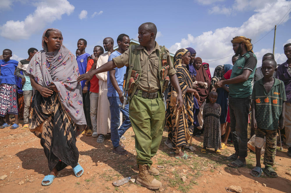 Residents gather for a planned distribution of food, after El Niño rains damaged their houses in Mandera County, Kenya, Wednesday. Rains began pounding the country in October. At the end of November Kenya President William Ruto convened an emergency cabinet meeting saying 38 of Kenya's 47 counties had been affected by floods and mudslides made worse by the El Niño phenomenon.