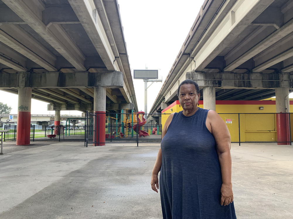 Amy Stelly, an artist, urban designer and community activist, stands beneath the Claiborne Expressway on July 18, 2023. Stelly, who lives nearby, is working with the LSU School of Public Health on an EPA study of the noise and air pollution from the highway, and still supports moving this stretch of I-10 away from the historically black community.