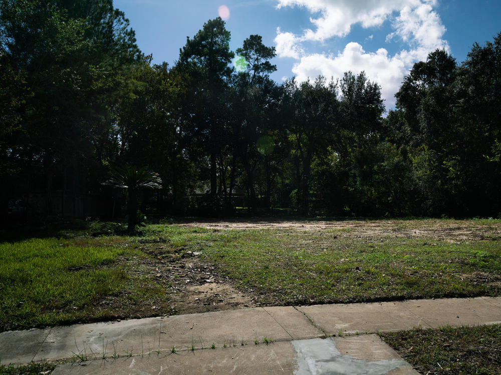 An empty lot where a house once stood in Houston. The former residents moved because of flood damage. A new study suggests that people are moving away from the most flood-prone neighborhoods in cities that are otherwise growing in population.