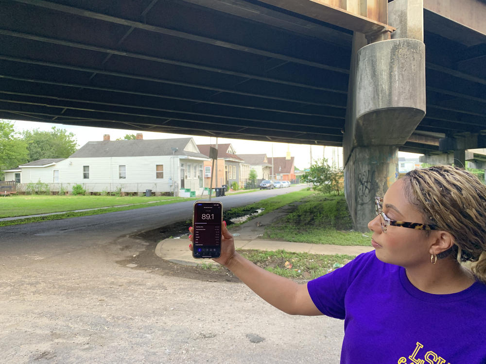 Graduate student researcher Jacquelynn Mornay, with the LSU School of Public Health, shows a noise reading taken beneath the Claiborne Expressway on July 18, 2023, in New Orleans. The decibel levels are similar to that of a motorcycle engine and could cause permanent hearing damage after prolonged exposure.