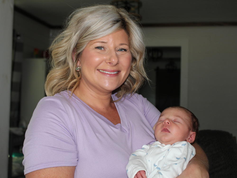 Deanna Buckins holds her sleeping infant, Hayden. The boy's birth was handled by the family's primary care doctor and was 