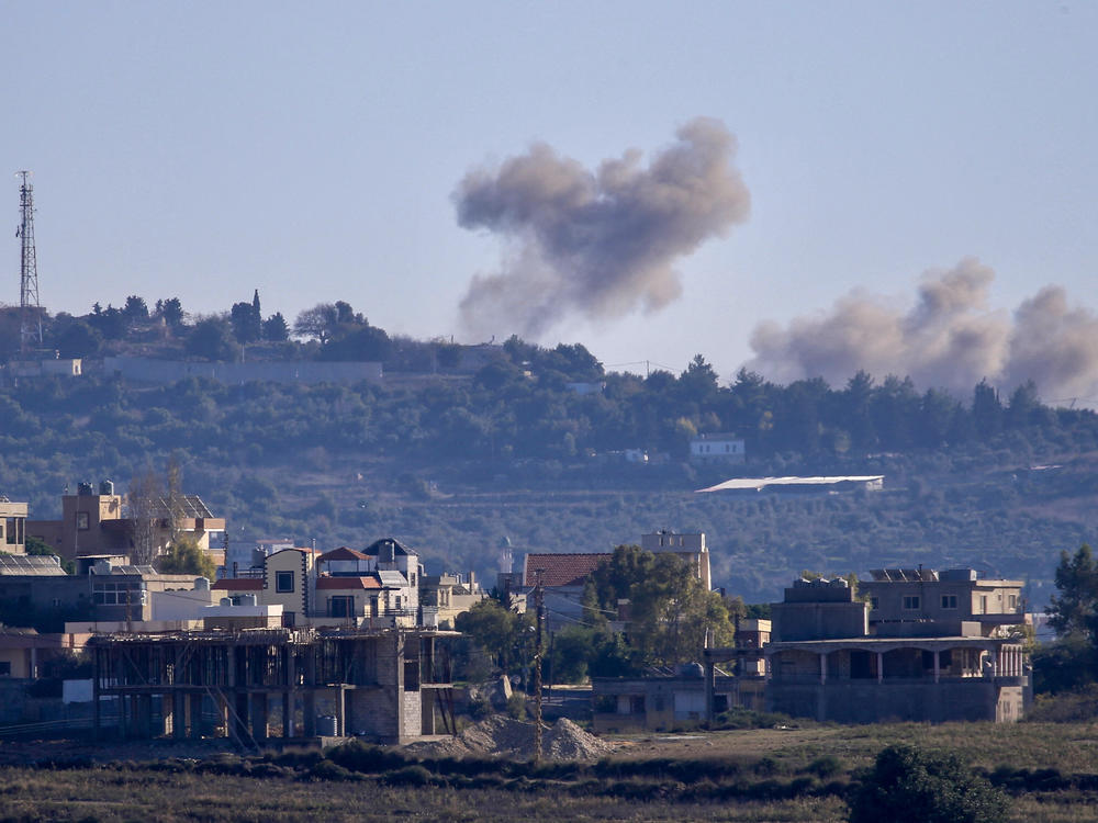 A picture taken from from the southern Lebanese village of Tayr Harfa, near the border with Israel, shows smoke billowing near an Israeli outpost from rockets fired by Hezbollah on Dec. 15.
