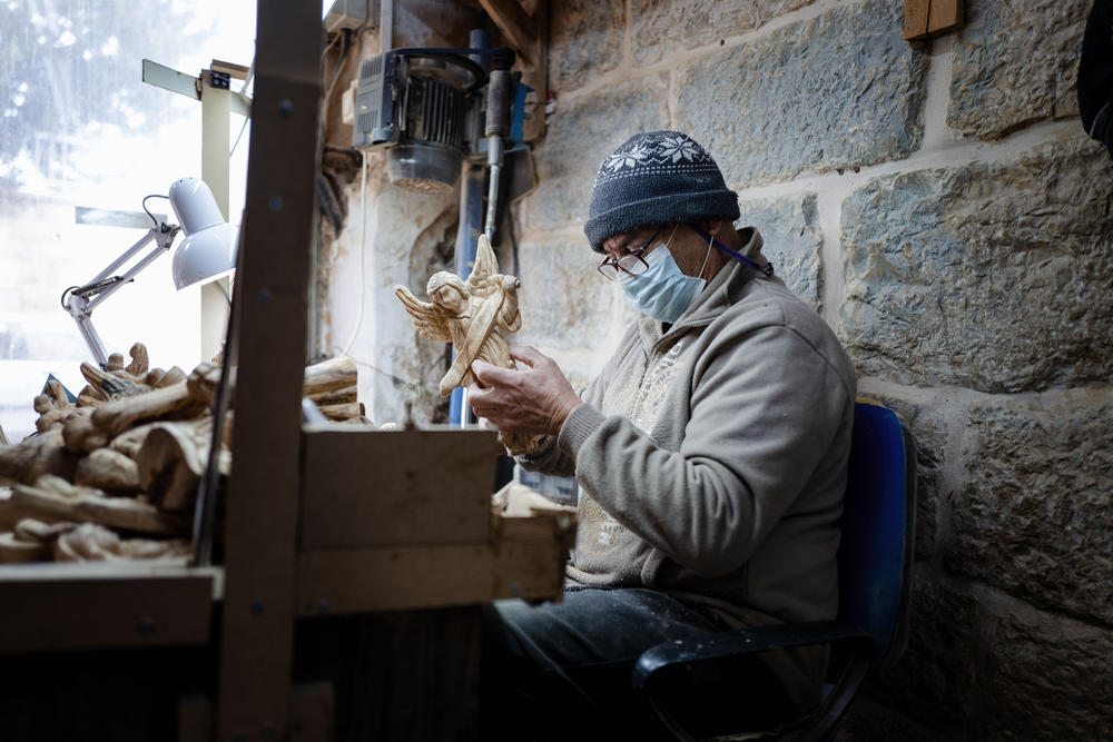 A woodworker inside Christmas House in Bethlehem.