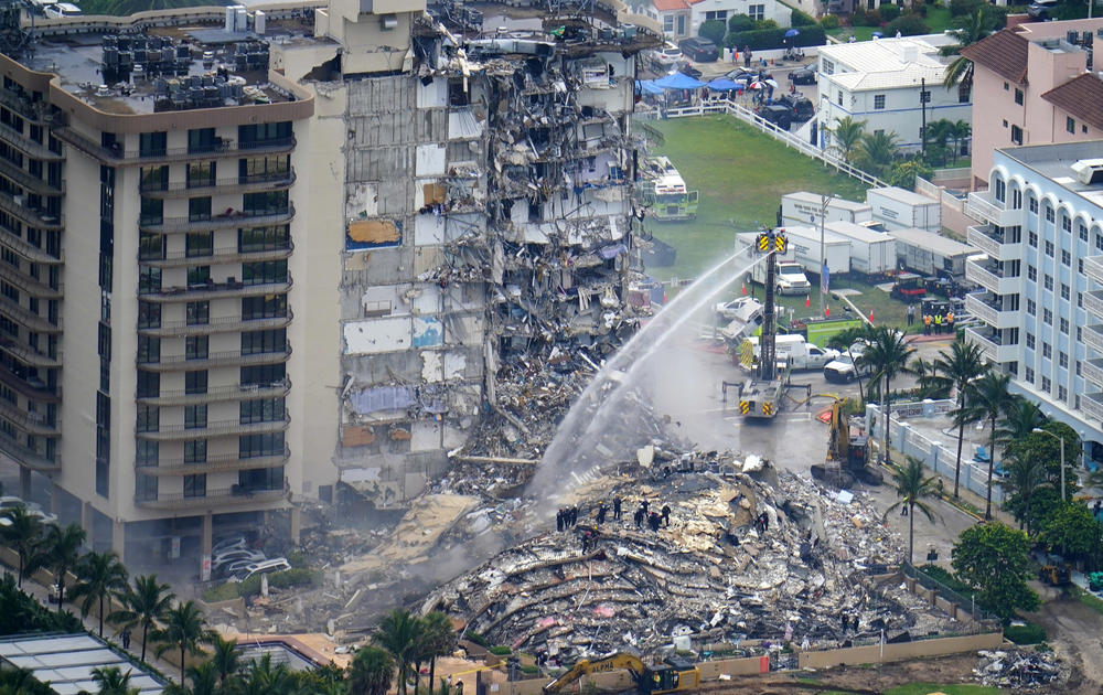 Rescue personnel work at the remains of the Champlain Towers South beachfront condo building in Surfside, Fla., after the June 2021 collapse that killed 98 people.