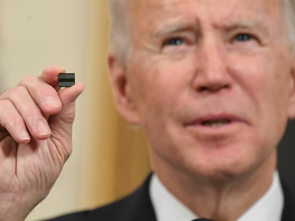 President Biden holds up a microchip at a White House event on Feb. 24, 2021.