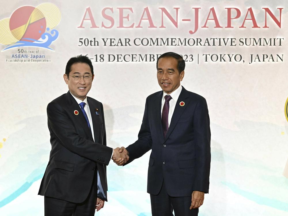 Japan's Prime Minister Fumio Kishida, left, greets Indonesia's President Joko Widodo upon arrival for the opening session of ASEAN-Japan Commemorative Summit Meeting at the Hotel Okura Tokyo in Tokyo Sunday, Dec. 17, 2023.