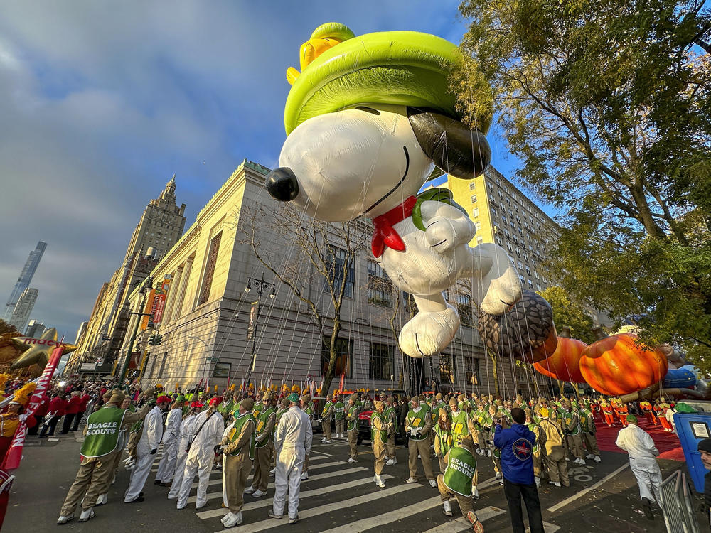 A Beagle Scout Snoopy balloon floats above Manhattan during the Macy's Thanksgiving Day Parade in November.