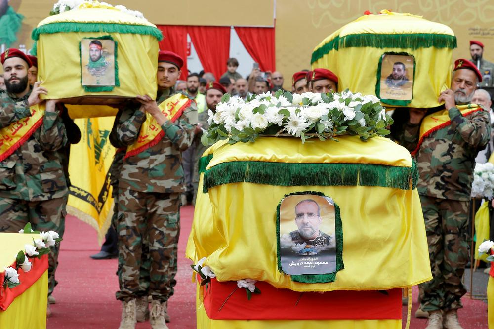 The caskets of three Hezbollah members killed in intensifying border skirmishes on the Lebanese-Israeli border are carried during their funeral in Lebanon's southern city of Nabatieh on Oct. 27, 2023.