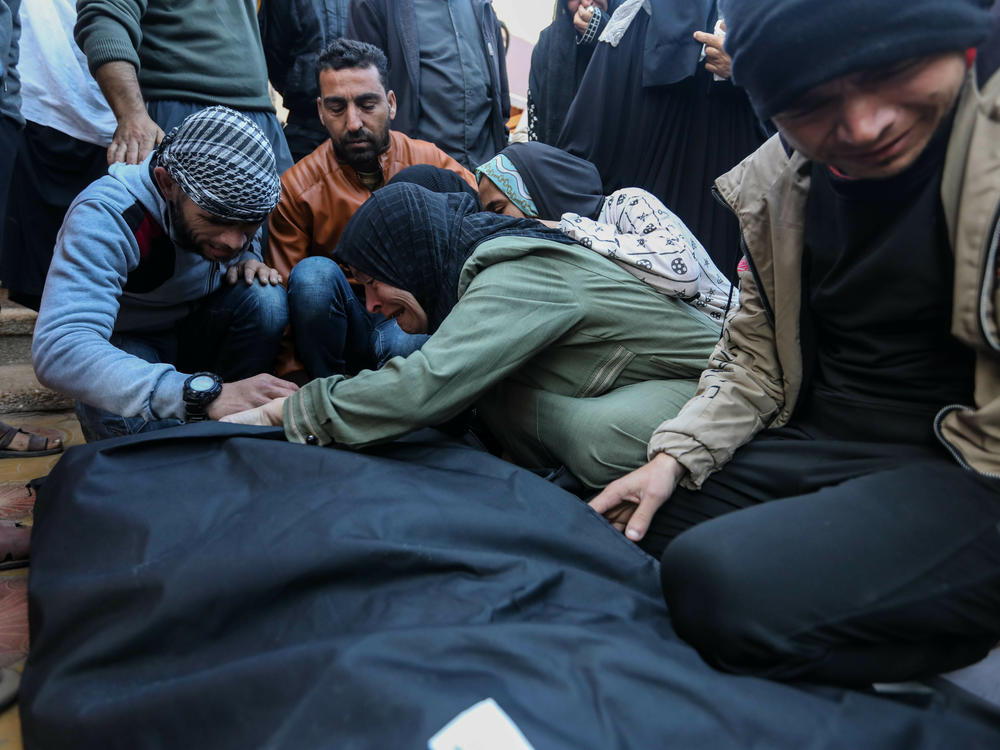 People mourn as they collect the bodies of Palestinians killed in an airstrike on Monday in Khan Yunis, Gaza. The United Kingdom, France and Germany are the latest countries to call on Israel to reach a 