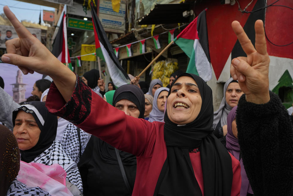 Palestinian women chant slogans during the observance of a global day of boycotts and strikes called for by pro-Palestinian activists to demand a ceasefire in Gaza, at Bourj al-Barajneh Palestinian refugee camp in Beirut, Lebanon, Monday, Dec. 11, 2023.