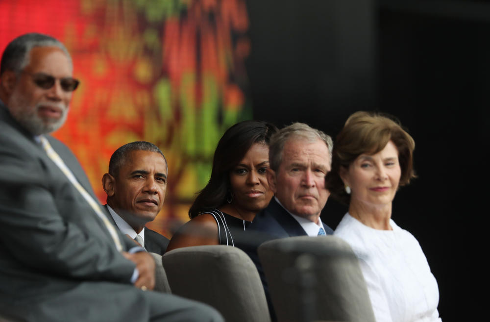 From left, Smithsonian Secretary Lonnie Bunch, President Barack Obama, first lady Michelle Obama, former President George W. Bush, and former first lady Laura Bush, listen to Stevie Wonder sing during the opening ceremony of the Smithsonian National Museum of African American History and Culture in Washington, D.C. on Saturday, Sept. 24, 2016.
