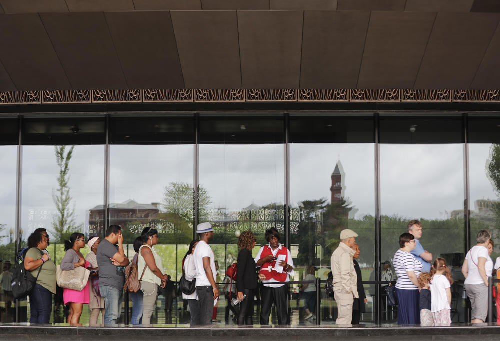 Visitors have their ticket scanned as they wait in line outside the Smithsonian National Museum of African American History and Cultural on the National Mall in Washington, Monday, May 1, 2017.