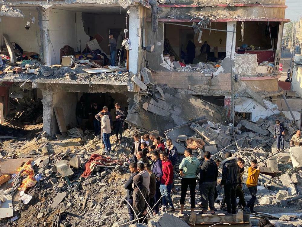 The civilian death toll in Gaza has led to growing calls for Israel to shift tactics in its assault on the Palestinian territory. Above, people survey the damage from an airstrike in Tel al-Sultan in Rafah.