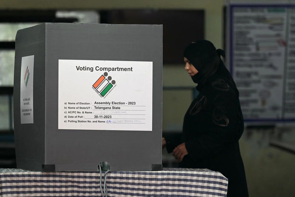 A woman casts her vote at a polling station during regional elections in Hyderabad, India, on Nov. 30. In 2024, India will be among a large number of countries holding important national elections.