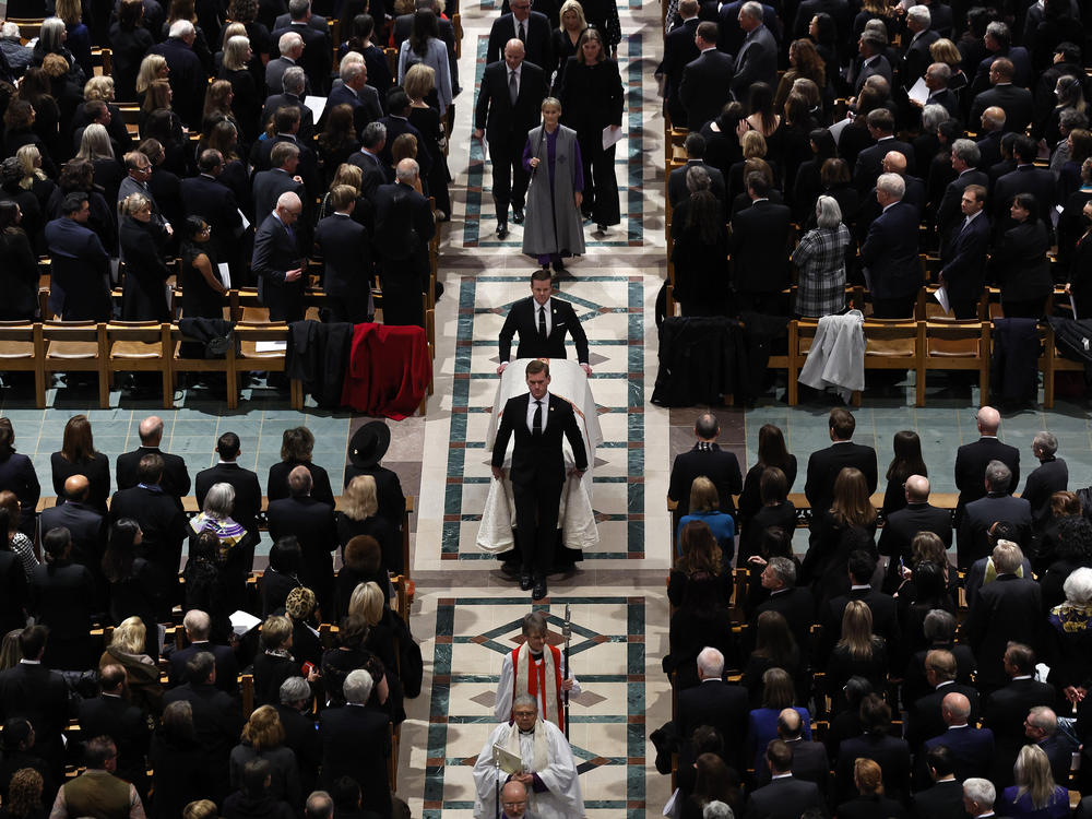 Supreme Court Justice Sandra Day O'Connor's casket is wheeled out of Washington National Cathedral at the conclusion of her funeral.